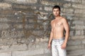 Muscular guy standing near the wall Royalty Free Stock Photo