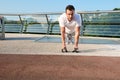 Muscular handsome attractive middle aged Caucasian man, determined athlete doing push ups from the floor during an intense outdoor