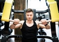 Muscular handsome man working out in the gym. Bodybuilding male hard training. Royalty Free Stock Photo