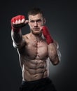 Muscular kickbox or muay thai fighter punching.