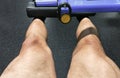 Muscular Legs doing exercise in gym machine, close up strong male quadriceps exercise workout. Photo image Royalty Free Stock Photo