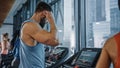 Muscular Male Athlete Uses Wireless Headphones, Plays Podcast or Training Playlist while Running on Royalty Free Stock Photo