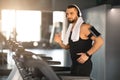 Muscular Male Athlete Wearing Wireless Headphones Running On Treadmill At Gym Royalty Free Stock Photo