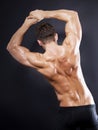 Muscular male back on black background Royalty Free Stock Photo