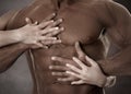 Muscular male body. Female hands Royalty Free Stock Photo