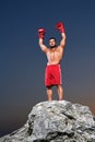 Muscular male boxer training outdoors