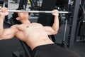 Muscular male having pain on shoulder in gym. young man injure