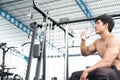 Muscular male having pain on shoulder in gym. young man injure