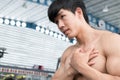 Muscular male having pain on shoulder in gym. young man injure