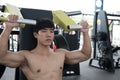 Muscular male having pain on shoulder in gym. young man injure