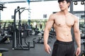 Muscular male having pain on shoulder in gym. young man injure