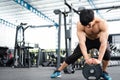 Muscular male having pain on shoulder in gym. young man injure