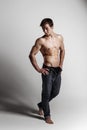 Muscular male model bodybuilder with unbuttoned jeans. Studio sh Royalty Free Stock Photo