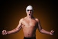 Muscular male swimmer with clenched fist is celebrating