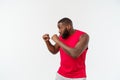 Muscular man of African descent isolated over a white background showing a closeup of his fists and knuckles. Shallow