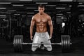 Muscular man athlete in fitness gym have havy workout. Fitness sports trainer on trainging with barbell.
