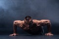 Muscular man doing calisthenic exercise  on the black background Royalty Free Stock Photo