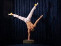 Muscular man doing exercise of handstand at home. Concept of yoga, creativity and healthy lifestyle
