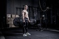 Muscular Man Doing Heavy Deadlift Exercise. Dramatic color grading.