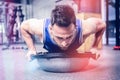 Muscular man doing push up on bosu ball