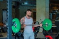 Muscular man doing workout with dumbbells in gym. Handsome man with big muscles posing in the gym. Muscular sportsman Royalty Free Stock Photo