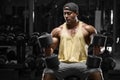 Muscular man with dumbbells working out in gym, strong arab bodybuilder male Royalty Free Stock Photo