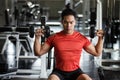 Muscular man exercise dumbbell in gym