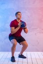 Muscular man exercise with medicine ball at health club. Fitness routine with exercise. Interactive coach concept Royalty Free Stock Photo