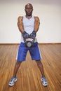 Muscular man exercising with kettle bell in gym Royalty Free Stock Photo