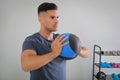 Muscular man exercising with medicine ball in modern gym Royalty Free Stock Photo