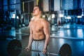 Muscular man, fitness trainer working out at gym and making biceps exercices Royalty Free Stock Photo