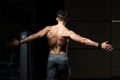 Muscular Man Flexing Back Muscles Pose Royalty Free Stock Photo