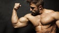 A muscular man flexing his biceps Royalty Free Stock Photo