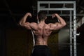 Muscular Man Flexing Muscles Rear Double Biceps Pose Royalty Free Stock Photo