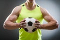 The muscular man with football ball Royalty Free Stock Photo