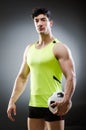 The muscular man with football ball Royalty Free Stock Photo