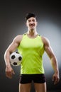 The muscular man with football ball Royalty Free Stock Photo