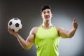 Muscular man with football ball Royalty Free Stock Photo