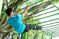 a muscular man in gym clothes doing hand exercises perfect pull-up for climbing strength