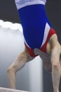 Muscular man gymnasts competing on the bar