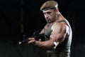 Muscular Man Holding Machine Gun Royalty Free Stock Photo