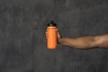 Muscular man holding an orange water bottle mockup Royalty Free Stock Photo