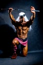 Muscular man in an image of a barbarian warrior with sword raise Royalty Free Stock Photo