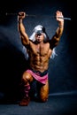 Muscular man in an image of a barbarian warrior with sword raise Royalty Free Stock Photo