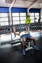 Muscular man lifting barebell while lying on bench Royalty Free Stock Photo