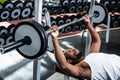 Muscular man lifting barebell while lying on bench Royalty Free Stock Photo