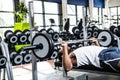 Muscular man lifting barebell while lying on bench Royalty Free Stock Photo