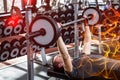 Muscular man lifting barebell while lying on bench Royalty Free Stock Photo