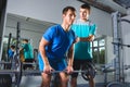 Muscular Man Lifting Deadlift In The Gym with instructor Royalty Free Stock Photo