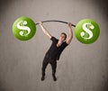 Muscular man lifting green dollar sign weights Royalty Free Stock Photo